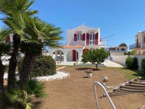 a house with a palm tree in front of it at Villa Peonia Luxury in Bisceglie