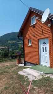 a house with a white door and a satellite at Sun-Moon Apartment in Zbilje