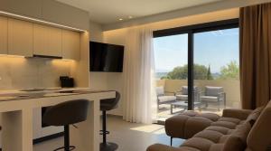 a kitchen and living room with a table and chairs at VITHΟS SUITE Luxury Living in Virós