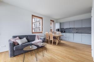 a living room with a couch and a table at AlmApp Nassfeld in Sonnenalpe Nassfeld