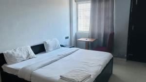 a large bed in a room with a window at Hotel Shivam Grand Inn in Gorakhpur
