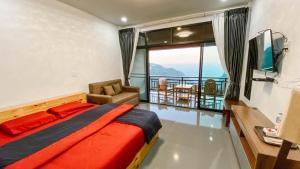 a bedroom with a bed and a balcony at ที่พัก in Ban Ko Doi Tung