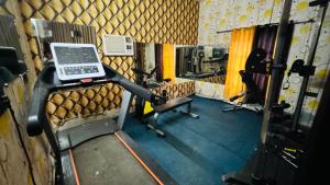 a room with a gym with a laptop on a machine at Hotel Shivam Grand Inn in Gorakhpur +20 photos
