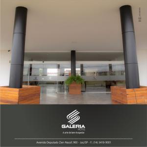 a room with columns and a table in a building at Galeria hotel in Jaú