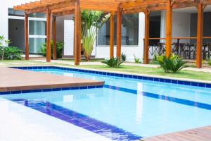 a swimming pool in a backyard with a house at Galeria hotel in Jaú
