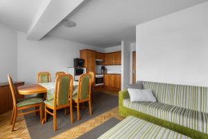 a living room with a table and chairs and a couch at Angela in Sonnenalpe Nassfeld