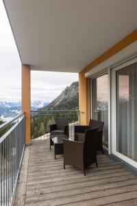 a balcony with chairs and a table on a deck at Lux 11 in Sonnenalpe Nassfeld