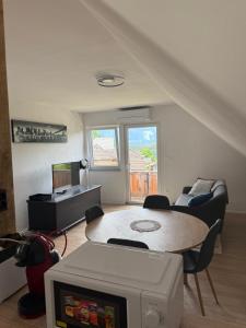 a living room with a table and a couch at Apartma Klemenc in Bohinj