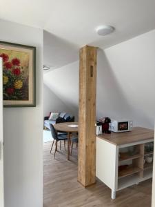 a kitchen and dining room with a table and chairs at Apartma Klemenc in Bohinj