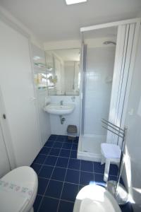 a bathroom with a toilet and a sink at Hotel BELLA ROMAGNA in Casal Borsetti +39 photos