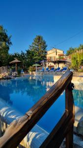 a view of a swimming pool from a wooden fence at Camping Bellevue in Ria
