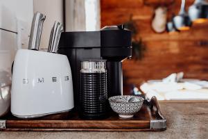 a coffee maker sitting on a wooden tray next to a cup at Drifting Sands Beachfront Retreat in Hokitika +69 photos
