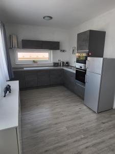 a kitchen with stainless steel appliances and a window at Apartmán Gabriela in Roudné