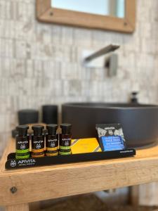 a counter with four bottles of spices next to a sink at Salvia di Astypalea in Livadi Astypalaias +51 photos