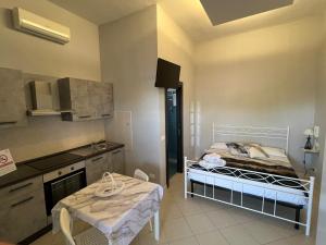 a kitchen with a bed and a table in a room at B&B Villa Anna in Sibari