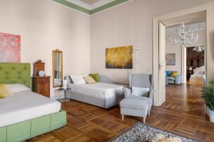 a bedroom with a bed and a couch and a chair at Luxury Historic Villa with heated pool near Catania, Taormina, the Sea and Mount Etna by SicilianRelaxingHomes in Giarre +91 photos