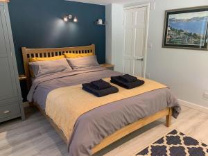a bedroom with a bed with two towels on it at The Cranny in Broxa