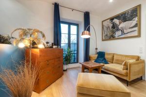 a living room with a couch and a dresser at Escale Rochelaise, chambre avec access spa et sauna in La Rochelle