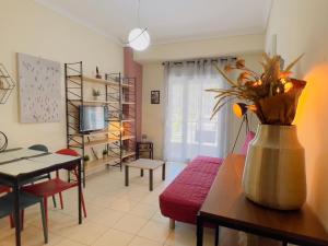 un soggiorno con un vaso di fiori su un tavolo di The Romantic Traveller a Kavala