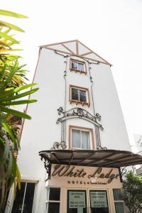 a building with a clock tower on top of it at White Lodge Hotel Bangkok in Bangkok