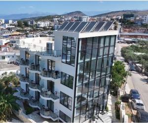 an apartment building with solar panels on top of it at BELSAR Hotel in Ksamil