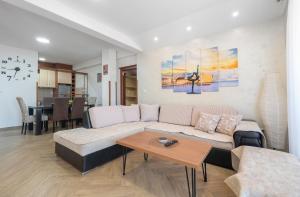 a living room with a couch and a table at Dobrljanin LUX apartment in Budva