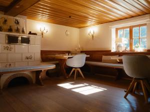 a kitchen with a table and chairs in a room at Boutique Hotel Mühle Schluchsee in Schluchsee