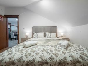 a bedroom with a large bed with two pillows on it at Dobrljanin LUX apartment in Budva