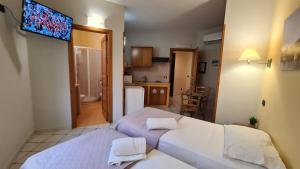 a room with a bed and a television on the wall at Sun Tower beach apartments in Mazara del Vallo