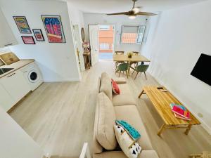 a living room with a couch and a table at La Casa de la Yaya - Malaga beach! in Málaga