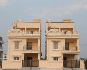 two story building with balconies on the sides of it at Luxury Villa Stays in Tirupati +5 photos
