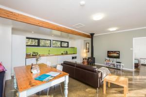 a living room with a table and a couch at Goosewing Cottage in Mount View