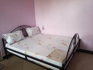 a small bed in a room with at Mumbai lodge in Bagamoyo