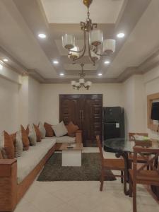 een woonkamer met een bank en een tafel bij SARAYA AWAD HEGAZI STREET- families only in Alexandrië