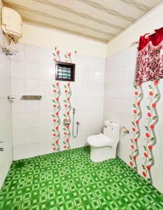 a bathroom with a toilet and a shower at Mist Nest Munnar in Munnar +15 photos