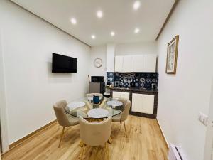 a kitchen and dining room with a glass table and chairs at La Zisa Luxury Apartment in Palermo