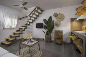 a living room with a spiral staircase and a table at Olympian Chalet in Paralia Katerinis