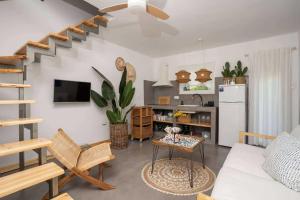 a living room with a couch and a kitchen at Olympian Chalet in Paralia Katerinis