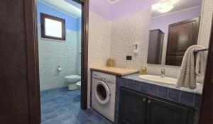 a bathroom with a washing machine and a sink at Sun Tower beach apartments in Mazara del Vallo +144 photos