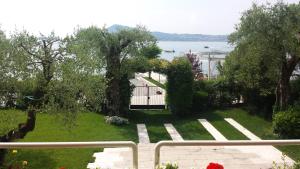 a view of a garden from the balcony of a house at Jane's Dream Apartment in San Felice del Benaco