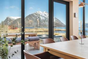 a dining room with a view of a mountain at Seafront Luxury Villa near Henningsvær in Kleppstad