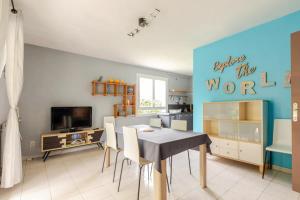 ein Esszimmer mit einem Tisch und einer blauen Wand in der Unterkunft Agréable logement avec piscine entre mer et vignes in Maureilhan-et-Raméjan