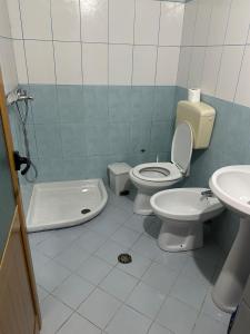a bathroom with a toilet and a sink at Villa Edi in Vlorë +41 photos
