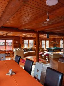 a living room with couches and a pool table at Magasbükk Drakula Kulcsosház Ivó in Izvoare