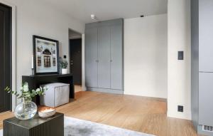 a large living room with white walls and wooden floors at New apartment at Majorstuen in Lii