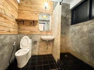 a bathroom with a toilet and a sink at White Lodge Hotel Bangkok in Bangkok +25 photos