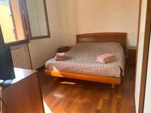 a small bedroom with a bed and a television at Annina residence in Ravenna