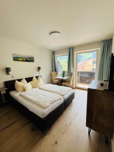 a bedroom with a large bed and a large window at Apartment Gastein 3 in Bad Gastein
