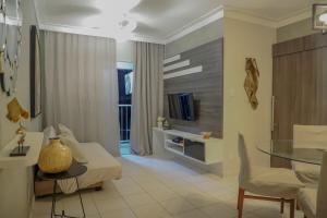 a living room with a couch and a glass table at Apartamento Atalaia Aracaju 3 quartos in Aracaju