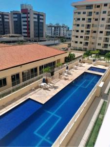 arial view of a swimming pool in a building at Apartamento Atalaia Aracaju 3 quartos in Aracaju